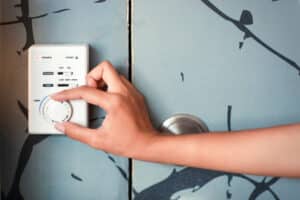 woman hand using thermostat